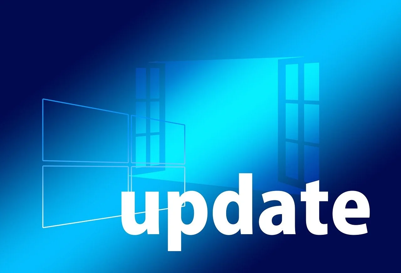 Blau leuchtender Bildschirm mit einem angedeuteten Windows-Fenster. Groß im Vordergrund steht das weiße Wort Update